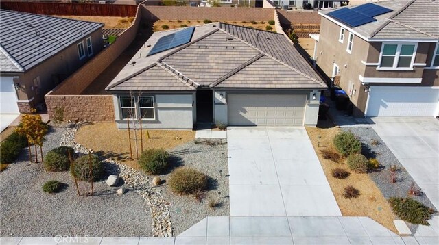 view of front of house with a garage and solar panels