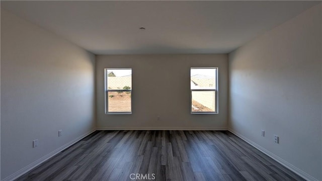 spare room featuring dark wood-type flooring