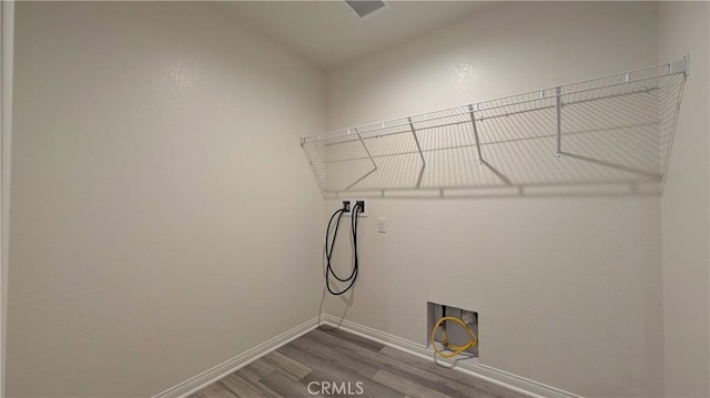 washroom with wood-type flooring and washer hookup