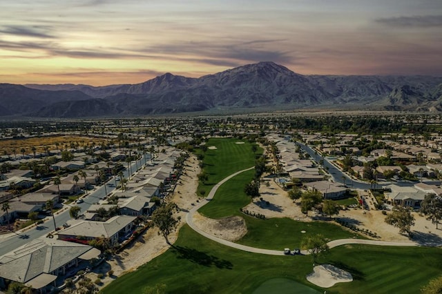 aerial view at dusk featuring a mountain view