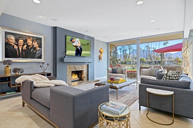 living room with light tile patterned floors, a fireplace, and expansive windows