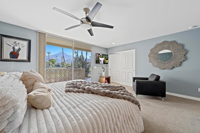 carpeted bedroom with floor to ceiling windows, access to outside, and ceiling fan