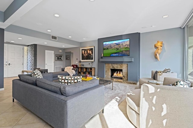 tiled living room featuring plenty of natural light and a high end fireplace