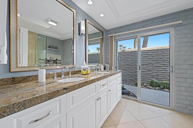 bathroom featuring vanity, tile patterned floors, ornamental molding, and a raised ceiling