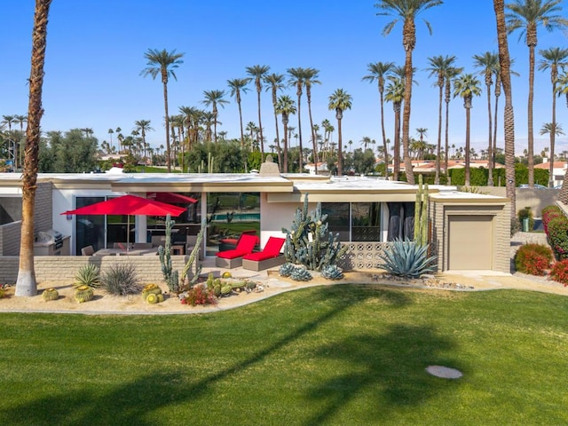 view of front of property featuring a garage and a front yard