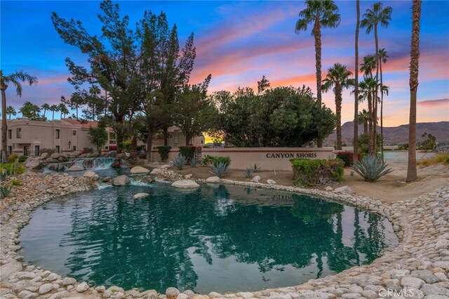 pool at dusk with a mountain view