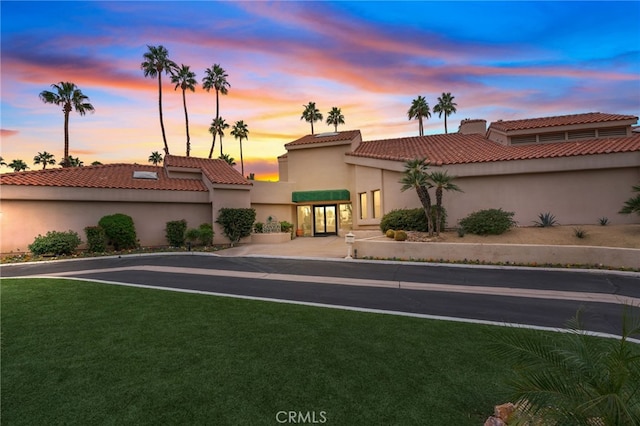 mediterranean / spanish-style home featuring a yard