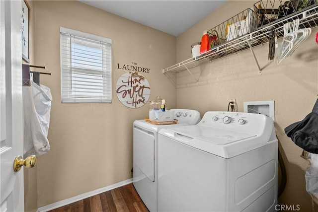 washroom with laundry area, dark wood-type flooring, independent washer and dryer, and baseboards