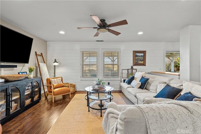 living room with hardwood / wood-style flooring and ceiling fan