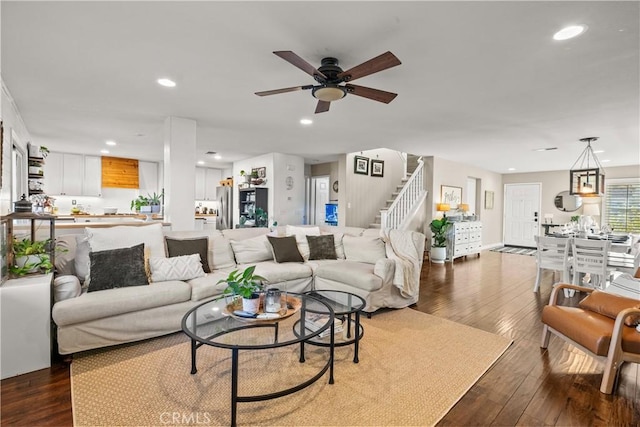 living room with stairs, dark wood finished floors, a ceiling fan, and recessed lighting