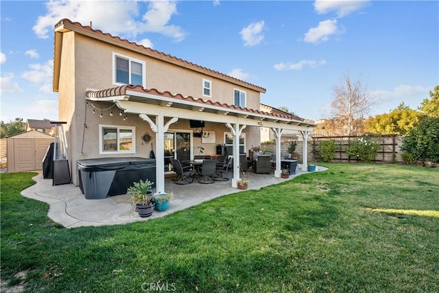 rear view of property featuring an outbuilding, a patio, stucco siding, a shed, and a fenced backyard