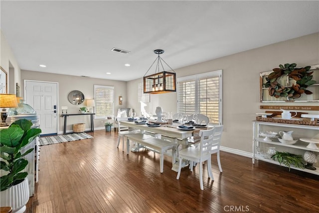 dining space with dark hardwood / wood-style floors