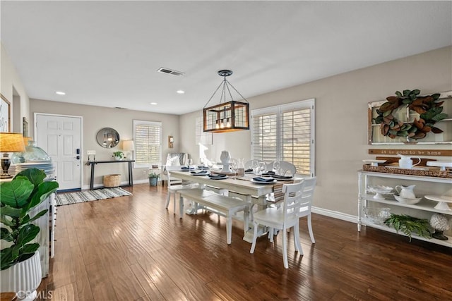 dining area with dark wood-type flooring, recessed lighting, visible vents, and baseboards