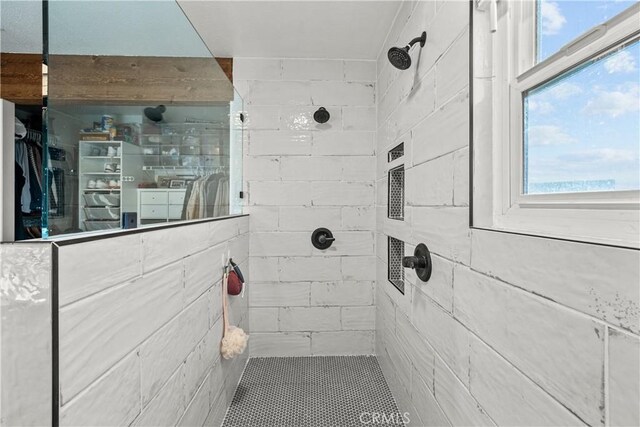 bathroom with a tile shower