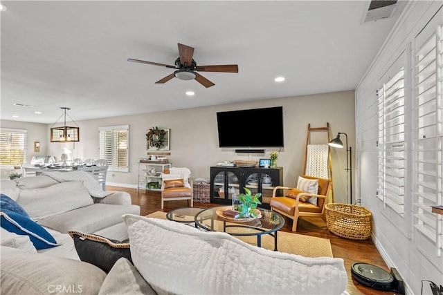 living room with hardwood / wood-style floors and ceiling fan