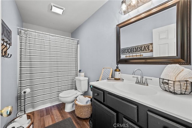 full bath featuring toilet, visible vents, wood finished floors, and vanity