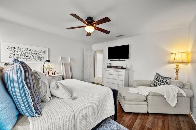 bedroom featuring visible vents, dark wood finished floors, and ceiling fan