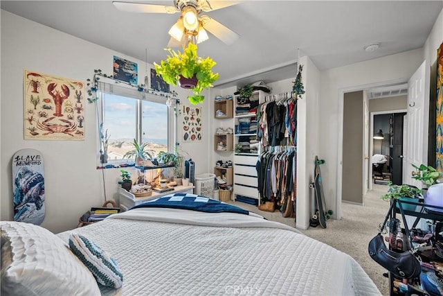 bedroom with light colored carpet, a closet, and ceiling fan