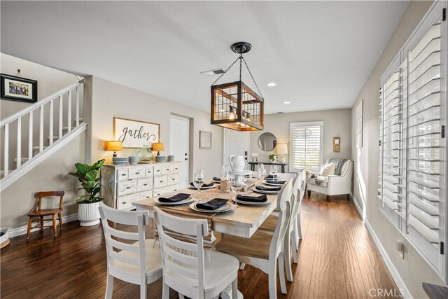 dining room featuring dark hardwood / wood-style flooring and a notable chandelier