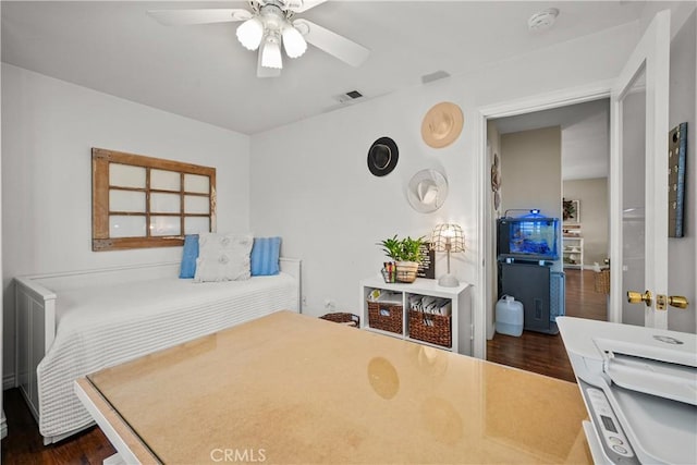 bedroom featuring visible vents, dark wood-type flooring, and a ceiling fan