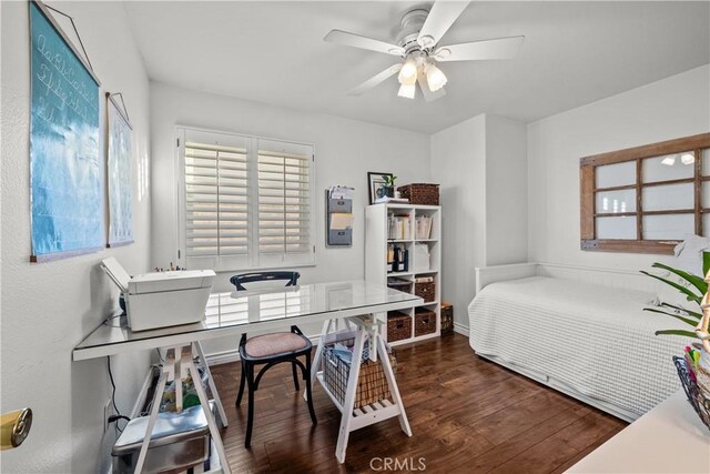 bedroom with dark hardwood / wood-style floors