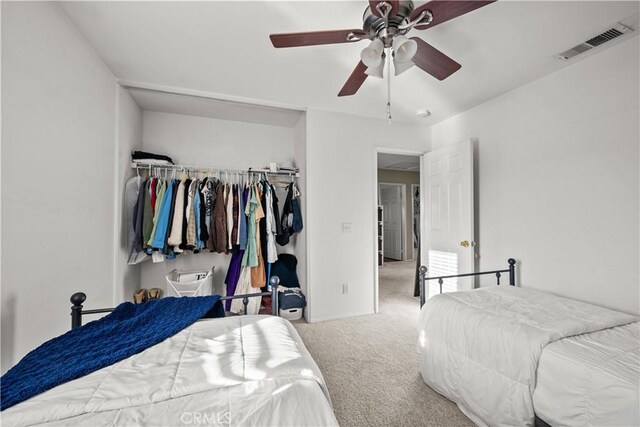 bedroom with a closet, ceiling fan, and carpet flooring