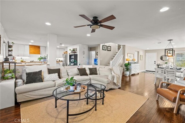 living room featuring dark hardwood / wood-style flooring and ceiling fan