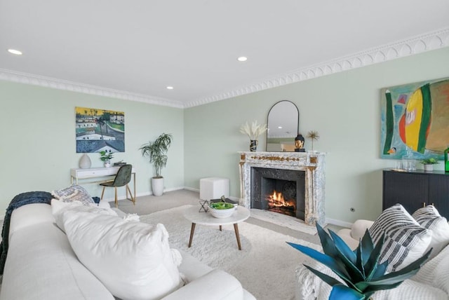 living room with crown molding, carpet, and a fireplace