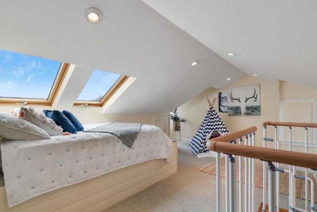 bedroom with lofted ceiling with skylight and light colored carpet