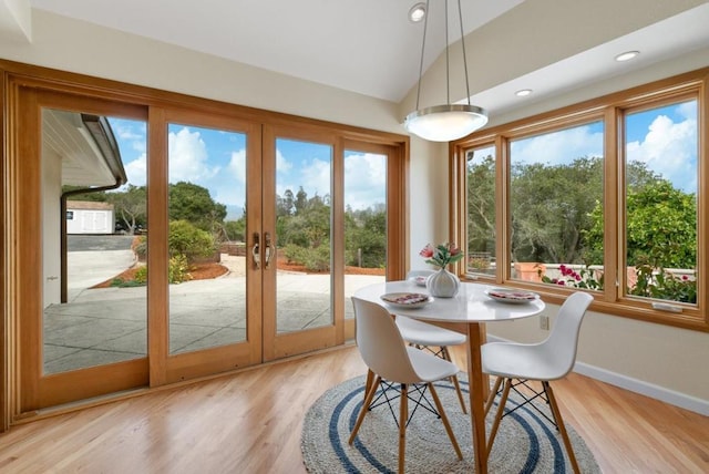 sunroom / solarium featuring french doors and lofted ceiling