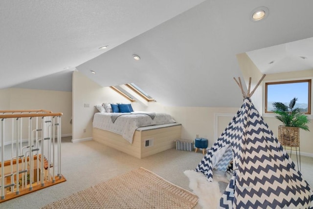 bedroom featuring light colored carpet, radiator heating unit, and lofted ceiling with skylight