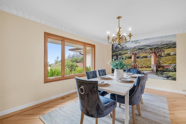 dining room featuring ornamental molding and a notable chandelier