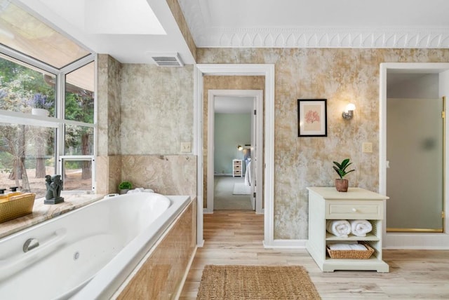 bathroom with a skylight, wood-type flooring, and separate shower and tub