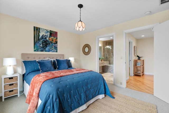 carpeted bedroom with ensuite bath