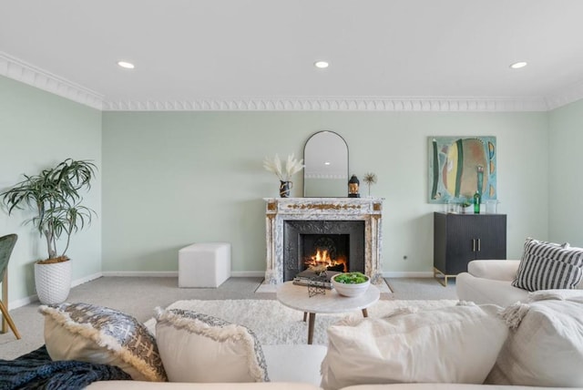 living room with ornamental molding, light carpet, and a fireplace