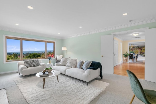 carpeted living room featuring crown molding