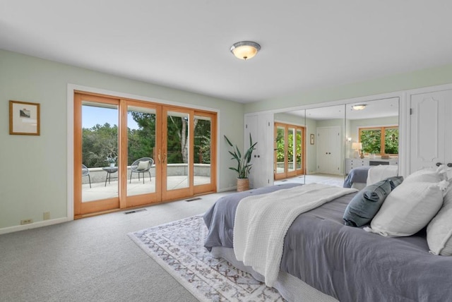 bedroom with multiple windows, access to outside, and french doors