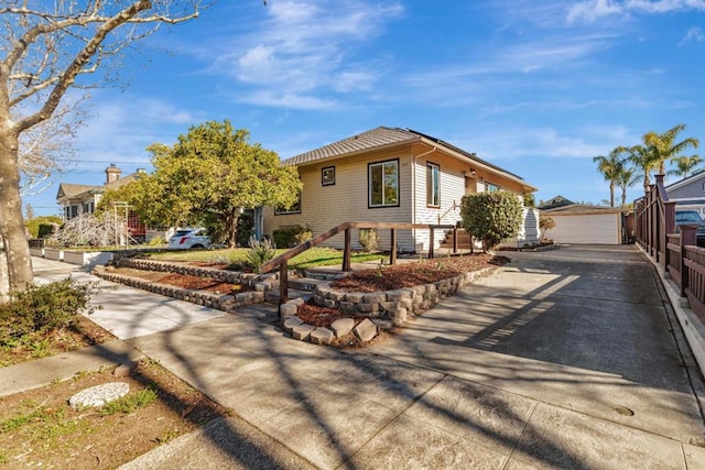 view of front of property with a garage and an outdoor structure