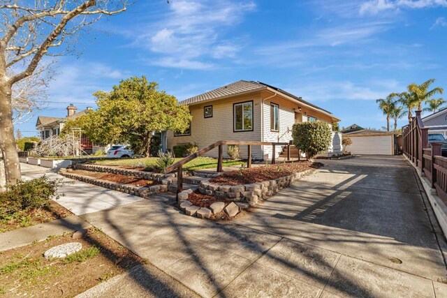 view of front of home with a garage and an outdoor structure