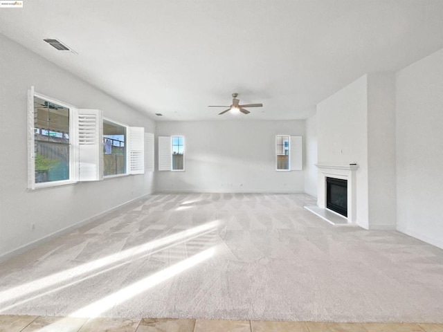 unfurnished living room featuring ceiling fan and light tile patterned flooring