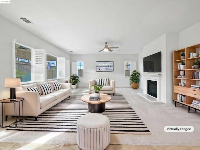 living room featuring light colored carpet and ceiling fan