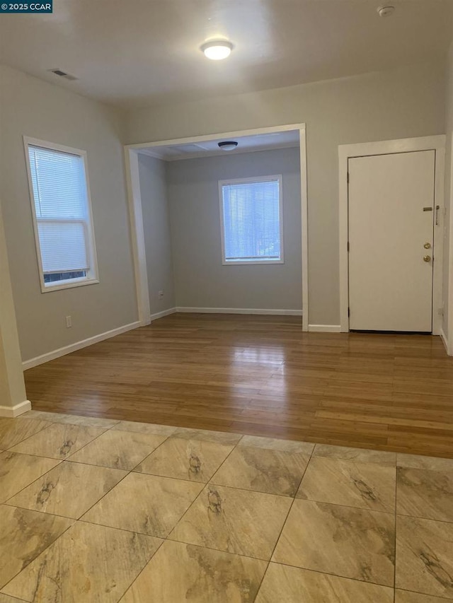 empty room with light hardwood / wood-style floors