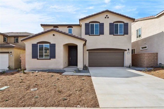 mediterranean / spanish-style home with a garage