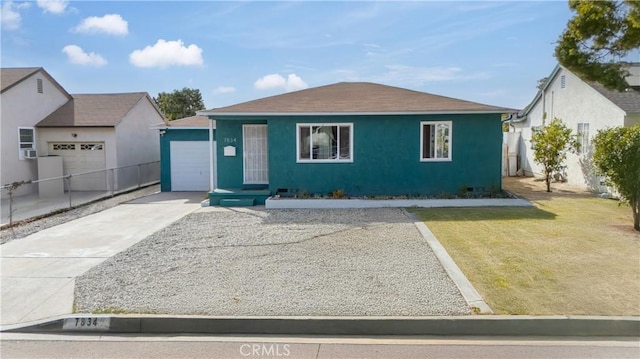 view of front of property with a garage and a front lawn