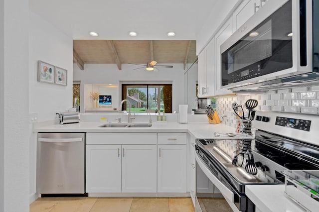 kitchen featuring stainless steel appliances, sink, and white cabinets