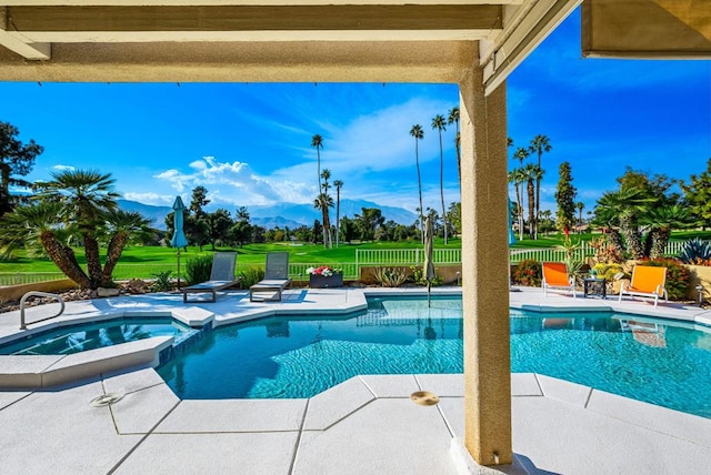 view of swimming pool featuring a mountain view, a patio, and an in ground hot tub