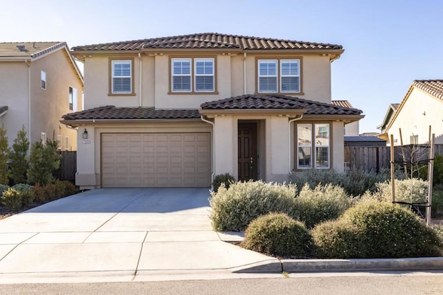 mediterranean / spanish-style home with a garage