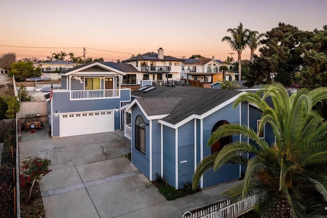 view of front of property featuring a garage and a balcony