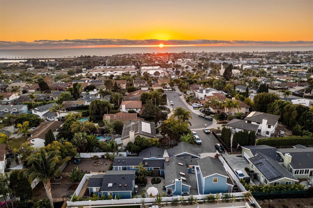 aerial view at dusk featuring a water view