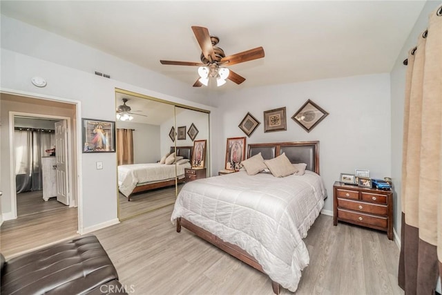 bedroom featuring light hardwood / wood-style floors, a closet, and ceiling fan